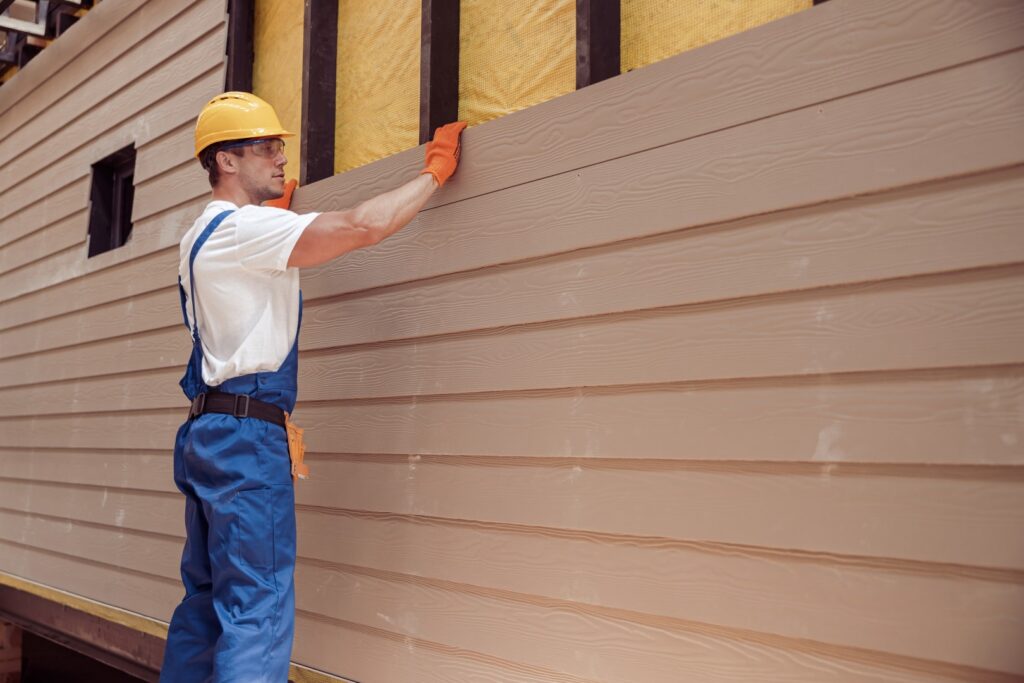 Fiber cement siding installation on a traditional suburban home.