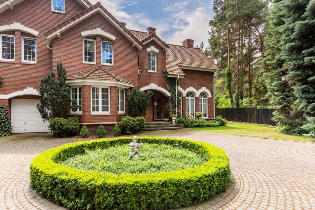 Large suburban home with a red brick masonry facade, showcasing a durable and elegant exterior.